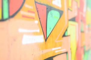 Background image with a colored graffiti pattern, which is applied to the concrete wall with aerosol paints. A lot of contours and fragments filled with paint, forming an interesting composition photo