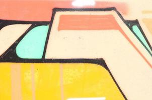 Background image with a colored graffiti pattern, which is applied to the concrete wall with aerosol paints. A lot of contours and fragments filled with paint, forming an interesting composition photo