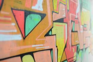 Background image with a colored graffiti pattern, which is applied to the concrete wall with aerosol paints. A lot of contours and fragments filled with paint, forming an interesting composition photo