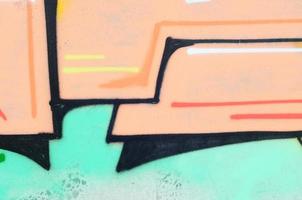 Background image with a colored graffiti pattern, which is applied to the concrete wall with aerosol paints. A lot of contours and fragments filled with paint, forming an interesting composition photo