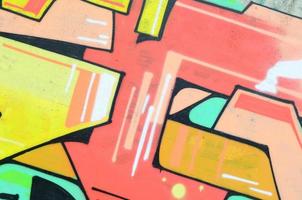 Background image with a colored graffiti pattern, which is applied to the concrete wall with aerosol paints. A lot of contours and fragments filled with paint, forming an interesting composition photo
