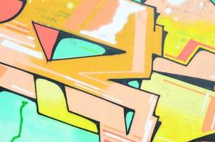 Background image with a colored graffiti pattern, which is applied to the concrete wall with aerosol paints. A lot of contours and fragments filled with paint, forming an interesting composition photo