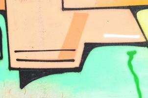 Background image with a colored graffiti pattern, which is applied to the concrete wall with aerosol paints. A lot of contours and fragments filled with paint, forming an interesting composition photo