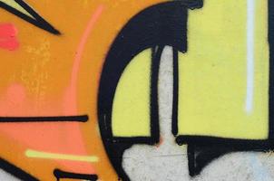 Background image with a colored graffiti pattern, which is applied to the concrete wall with aerosol paints. A lot of contours and fragments filled with paint, forming an interesting composition photo
