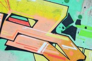 Background image with a colored graffiti pattern, which is applied to the concrete wall with aerosol paints. A lot of contours and fragments filled with paint, forming an interesting composition photo