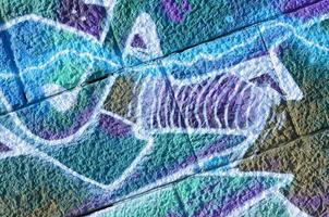 Fragment of graffiti drawings. The old wall decorated with paint stains in the style of street art culture. Colored background texture in cold tones photo