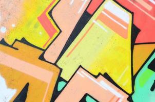 Background image with a colored graffiti pattern, which is applied to the concrete wall with aerosol paints. A lot of contours and fragments filled with paint, forming an interesting composition photo