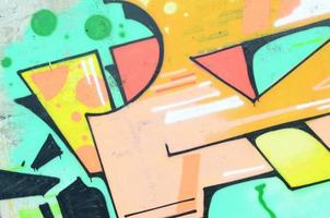 Background image with a colored graffiti pattern, which is applied to the concrete wall with aerosol paints. A lot of contours and fragments filled with paint, forming an interesting composition photo