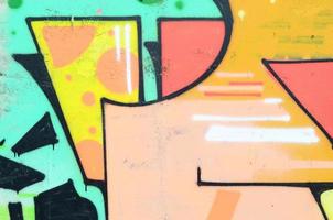 Background image with a colored graffiti pattern, which is applied to the concrete wall with aerosol paints. A lot of contours and fragments filled with paint, forming an interesting composition photo