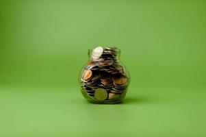 Money in a glass jar, coin savings concept photo