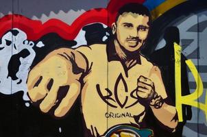 The old wall, painted in color graffiti drawing with aerosol paints. The image of the famous young Ukrainian boxer - Oleksandr Usyk photo