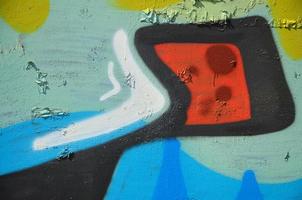 The old wall, painted in color graffiti drawing green aerosol paints. Background image on the theme of drawing graffiti and street art photo