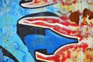 The old wall, painted in color graffiti drawing blue aerosol paints. Background image on the theme of drawing graffiti and street art photo