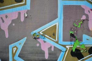 The old wall, painted in color graffiti drawing with aerosol paints. Background image on the theme of drawing graffiti and street art photo