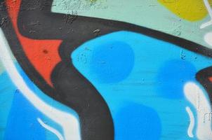 The old wall, painted in color graffiti drawing blue aerosol paints. Background image on the theme of drawing graffiti and street art photo