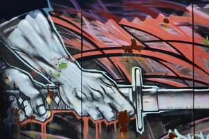 The old wall, painted in color graffiti drawing red aerosol paints. Background image on the theme of drawing graffiti and street art photo