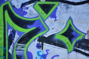 The old wall, painted in color graffiti drawing blue aerosol paints. Background image on the theme of drawing graffiti and street art photo