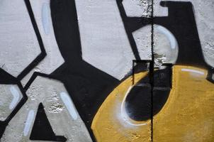 Texture of a fragment of the wall with graffiti painting, which is depicted on it. An image of a piece of graffiti drawing as a photo on street art and graffiti culture topics