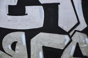 Texture of a fragment of the wall with graffiti painting, which is depicted on it. An image of a piece of graffiti drawing as a photo on street art and graffiti culture topics