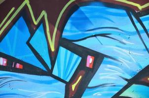 The old wall, painted in color graffiti drawing blue aerosol paints. Background image on the theme of drawing graffiti and street art photo