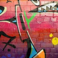 Abstract colorful fragment of graffiti paintings on old brick wall. Street art composition with parts of unwritten letters and multicolored stains. Subcultural background texture photo