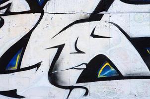 The old wall, painted in color graffiti drawing red aerosol paints. Background image on the theme of drawing graffiti and street art photo