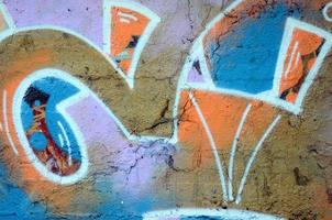 The old wall, painted in color graffiti drawing red aerosol paints. Background image on the theme of drawing graffiti and street art photo