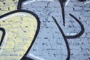 The old wall, painted in color graffiti drawing blue aerosol paints. Background image on the theme of drawing graffiti and street art photo