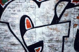 The old wall, painted in color graffiti drawing red aerosol paints. Background image on the theme of drawing graffiti and street art photo