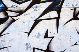 The old wall, painted in color graffiti drawing red aerosol paints. Background image on the theme of drawing graffiti and street art photo