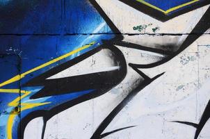 The old wall, painted in color graffiti drawing red aerosol paints. Background image on the theme of drawing graffiti and street art photo