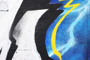 The old wall, painted in color graffiti drawing red aerosol paints. Background image on the theme of drawing graffiti and street art photo