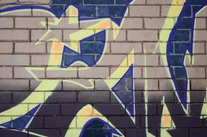 The old wall, painted in color graffiti drawing red aerosol paints. Background image on the theme of drawing graffiti and street art photo
