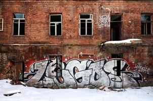 The old wall, painted in color graffiti drawing red aerosol paints. Background image on the theme of drawing graffiti and street art photo