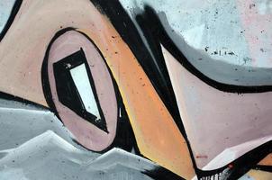 The old wall, painted in color graffiti drawing red aerosol paints. Background image on the theme of drawing graffiti and street art photo