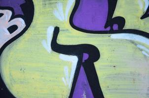 The old wall, painted in color graffiti drawing red aerosol paints. Background image on the theme of drawing graffiti and street art photo