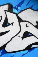 Background image of a concrete wall with a piece of abstract graffiti pattern. Street art, vandalism and youth hobbies photo