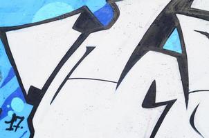 Background image of a concrete wall with a piece of abstract graffiti pattern. Street art, vandalism and youth hobbies photo