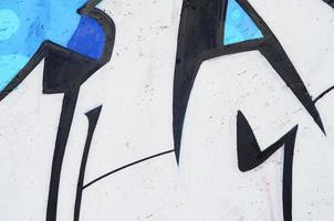 Background image of a concrete wall with a piece of abstract graffiti pattern. Street art, vandalism and youth hobbies photo