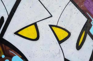 Background image of a concrete wall with a piece of abstract graffiti pattern. Street art, vandalism and youth hobbies photo