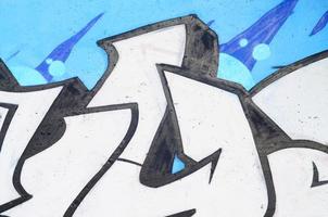 Background image of a concrete wall with a piece of abstract graffiti pattern. Street art, vandalism and youth hobbies photo