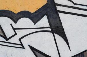 Background image of a concrete wall with a piece of abstract graffiti pattern. Street art, vandalism and youth hobbies photo