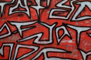 Background image of a concrete wall with a piece of abstract graffiti pattern. Street art, vandalism and youth hobbies photo