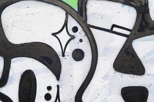 Background image of a concrete wall with a piece of abstract graffiti pattern. Street art, vandalism and youth hobbies photo