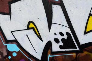 Background image of a concrete wall with a piece of abstract graffiti pattern. Street art, vandalism and youth hobbies photo