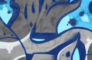 Background image of a concrete wall with a piece of abstract graffiti pattern. Street art, vandalism and youth hobbies photo