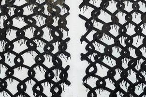 Background image of a concrete wall with a piece of abstract graffiti pattern. Street art, vandalism and youth hobbies photo