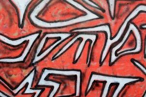 Background image of a concrete wall with a piece of abstract graffiti pattern. Street art, vandalism and youth hobbies photo