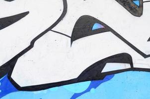 Background image of a concrete wall with a piece of abstract graffiti pattern. Street art, vandalism and youth hobbies photo