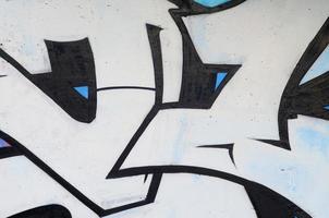 Background image of a concrete wall with a piece of abstract graffiti pattern. Street art, vandalism and youth hobbies photo
